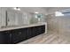 Bathroom featuring dual vanities with granite countertops and a frameless glass shower at 4909 Drawdy Ct, St Cloud, FL 34772