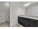 Bathroom with a granite countertop and black cabinets at 4909 Drawdy Ct, St Cloud, FL 34772