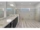 Stylish bathroom with granite countertops, a glass-enclosed shower, and double sinks at 4909 Drawdy Ct, St Cloud, FL 34772