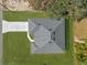 Overhead view of home with a gray roof, green lawn, and long driveway at 505 St Johns Ct, Kissimmee, FL 34759