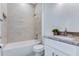 Bright bathroom featuring a tub with tile surround, stylish vanity, and modern fixtures at 505 St Johns Ct, Kissimmee, FL 34759