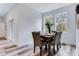 Bright dining room with wood-look floors, modern table set, and natural light from large windows at 505 St Johns Ct, Kissimmee, FL 34759