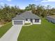 Charming single-story home with a gray roof, driveway, and well-kept lawn at 505 St Johns Ct, Kissimmee, FL 34759