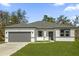 Charming single-story home featuring a well-manicured lawn, attached two-car garage and neutral gray and white color scheme at 505 St Johns Ct, Kissimmee, FL 34759