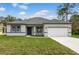 Charming single-story home featuring a well-manicured lawn, neutral paint, and a two-car garage at 505 St Johns Ct, Kissimmee, FL 34759