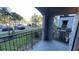 Condo balcony with metal railings, offering views of the parking lot and nearby landscaping at 5526 G Nw Ave # 4915, Orlando, FL 32815