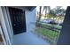 Exterior condo balcony with a door and metal railing, providing an elevated outdoor living space and parking lot views at 5526 G Nw Ave # 4915, Orlando, FL 32815