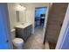 Bathroom featuring a tiled floor, shower, and gray vanity with a white countertop and large mirror at 5526 G Nw Ave # 4915, Orlando, FL 32815