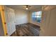 Comfortable bedroom with wood-look floors, a ceiling fan, and ample natural light at 5526 G Nw Ave # 4915, Orlando, FL 32815