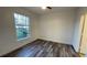 Bedroom with a ceiling fan, wood-look flooring, and view of the landscaped exterior at 5526 G Nw Ave # 4915, Orlando, FL 32815