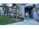 Exterior view of a well-maintained condo building with lush landscaping and stairway access to upper units at 5526 G Nw Ave # 4915, Orlando, FL 32815