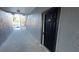 Exterior hallway leading to a unit featuring a black door with visible unit number against a gray building exterior at 5526 G Nw Ave # 4915, Orlando, FL 32815