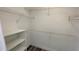 Spacious walk-in closet with ample shelving, providing optimal storage solutions at 5526 G Nw Ave # 4915, Orlando, FL 32815