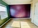 Bedroom with unique purple wall, light wood flooring, and bright sunlight from large window at 561 Telfair Square Ct, Sanford, FL 32771