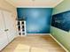 Cozy bedroom featuring modern shelving, wood laminate floors, and a striking chalkboard wall at 561 Telfair Square Ct, Sanford, FL 32771