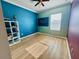 Colorful bedroom features wood-look floors and ceiling fan at 561 Telfair Square Ct, Sanford, FL 32771