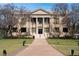 Classic city hall building with grand columns, American and Floridian flags, and manicured lawn at 5929 Cliffbow Loop, Leesburg, FL 34748