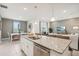 Open living space with kitchen island, dining area and living room in the background at 5929 Cliffbow Loop, Leesburg, FL 34748