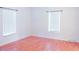 Spacious bedroom with two windows and wood-look floors at 630 Carpenter Rd, Orlando, FL 32833