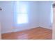 Bright bedroom featuring laminate floors, white walls, and natural light streaming through the window at 630 Carpenter Rd, Orlando, FL 32833