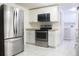 Modern kitchen featuring stainless steel appliances, granite countertops, and white cabinetry at 630 Carpenter Rd, Orlando, FL 32833