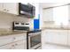 Well-equipped kitchen showcasing stainless steel appliances, granite countertops, and white cabinets at 630 Carpenter Rd, Orlando, FL 32833