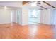 Open-concept living area with laminate floors flowing into a bright, white kitchen with modern cabinets at 630 Carpenter Rd, Orlando, FL 32833