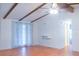 Bright living room featuring wood beams, a ceiling fan and wood flooring at 630 Carpenter Rd, Orlando, FL 32833