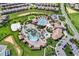 Aerial view of an amazing community pool area with mature landscaping at 635 Ocean Course Ave # 635, Champions Gate, FL 33896