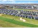 An aerial view shows a residential community surrounding a golf course and sand trap at 635 Ocean Course Ave # 635, Champions Gate, FL 33896