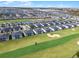 An aerial view shows a residential community surrounding a golf course and sand trap at 635 Ocean Course Ave # 635, Champions Gate, FL 33896