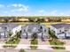 Aerial view of townhomes with brick driveways and golf course, perfect for recreation at 635 Ocean Course Ave # 635, Champions Gate, FL 33896