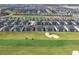 An aerial view shows a residential community surrounding a golf course and sand trap at 635 Ocean Course Ave # 635, Champions Gate, FL 33896