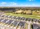 This aerial view highlights residential homes bordering a well-maintained golf course under a blue sky at 635 Ocean Course Ave # 635, Champions Gate, FL 33896