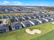 An aerial view shows a residential community surrounding a golf course and sand trap at 635 Ocean Course Ave # 635, Champions Gate, FL 33896