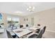 Bright dining room featuring a modern table setting, chandelier, and sliding glass doors to an outdoor patio at 635 Ocean Course Ave # 635, Champions Gate, FL 33896