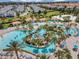 Large community pool has an island, lazy river and lounge seating at 635 Ocean Course Ave # 635, Champions Gate, FL 33896