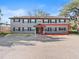 Exterior shot of a two-story apartment building with neutral siding, dark shutters, and a spacious parking area at 640 Robinhood Dr # B, Maitland, FL 32751