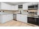 Well-lit kitchen featuring white cabinetry and stainless steel appliances at 640 Robinhood Dr # B, Maitland, FL 32751