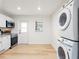 Modern laundry area featuring stacked washer/dryer and access to kitchen at 640 Robinhood Dr # B, Maitland, FL 32751