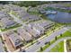 An aerial view of a residential community featuring modern homes, a lake, and a community pool at 652 Kimber Ln, Debary, FL 32713