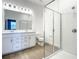 Bright bathroom featuring a double vanity, a large glass-enclosed shower with white subway tile, and modern fixtures at 652 Kimber Ln, Debary, FL 32713