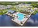 Aerial shot showcases a community pool and recreational area with lake views and surrounding homes at 652 Kimber Ln, Debary, FL 32713