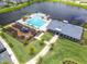 An aerial view of the community pool, playground, and clubhouse, beautifully situated by the lake at 652 Kimber Ln, Debary, FL 32713