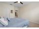 Bedroom with a ceiling fan, a queen bed, and an open doorway at 8031 Enchantment Dr # Ge, Windermere, FL 34786