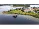 Waterfront property featuring a private dock, lush lawn, and spacious home at 8774 Bayview Crossing Dr, Winter Garden, FL 34787