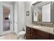 Elegant bathroom featuring granite countertops and wood cabinets, creating a luxurious feel at 8774 Bayview Crossing Dr, Winter Garden, FL 34787