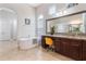 Elegant bathroom with a soaking tub, vanity, granite countertop, and tiled flooring at 8774 Bayview Crossing Dr, Winter Garden, FL 34787