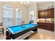 Fun game room with a pool table, wet bar, and lots of natural light at 8774 Bayview Crossing Dr, Winter Garden, FL 34787