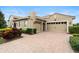 Spacious garage with a brick paved driveway and lush landscaping at 8774 Bayview Crossing Dr, Winter Garden, FL 34787